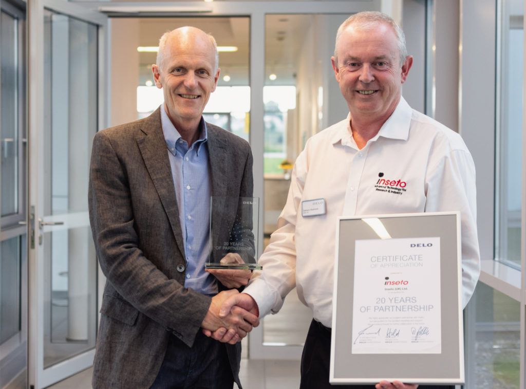 Robert Saller of DELO presenting Eamonn Redmond of Inseto with a 20 years of Partnership Certificate